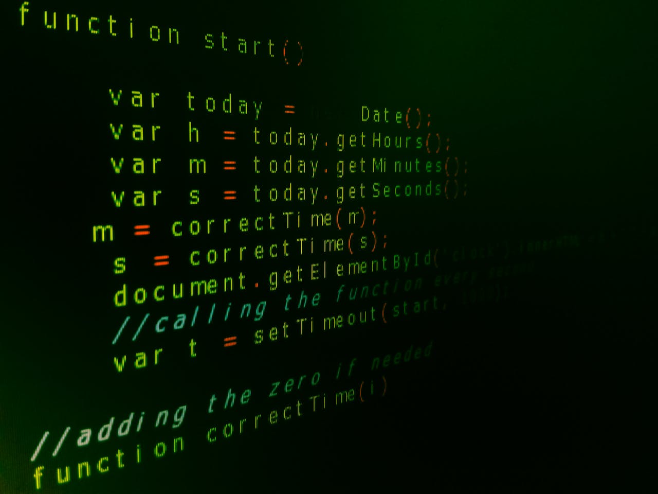 Close-up of JavaScript code on a computer screen with green text highlighting syntax.